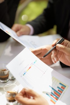 Businesspeople in a Cafe Discussing Report